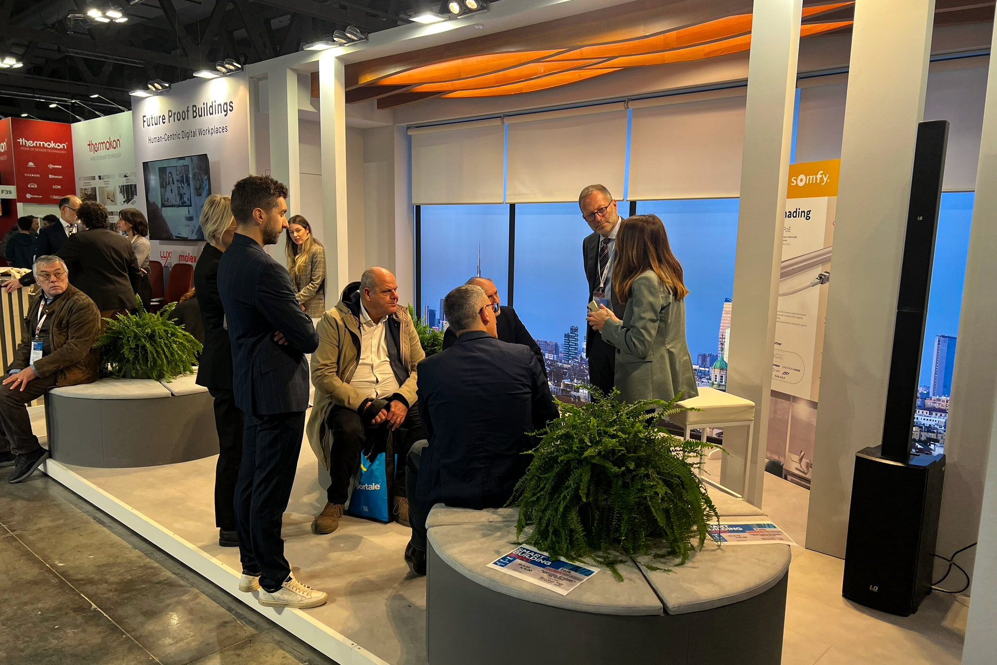 A panel discussion at a building automation expo featuring speakers discussing digital platforms for real estate and decarbonization.