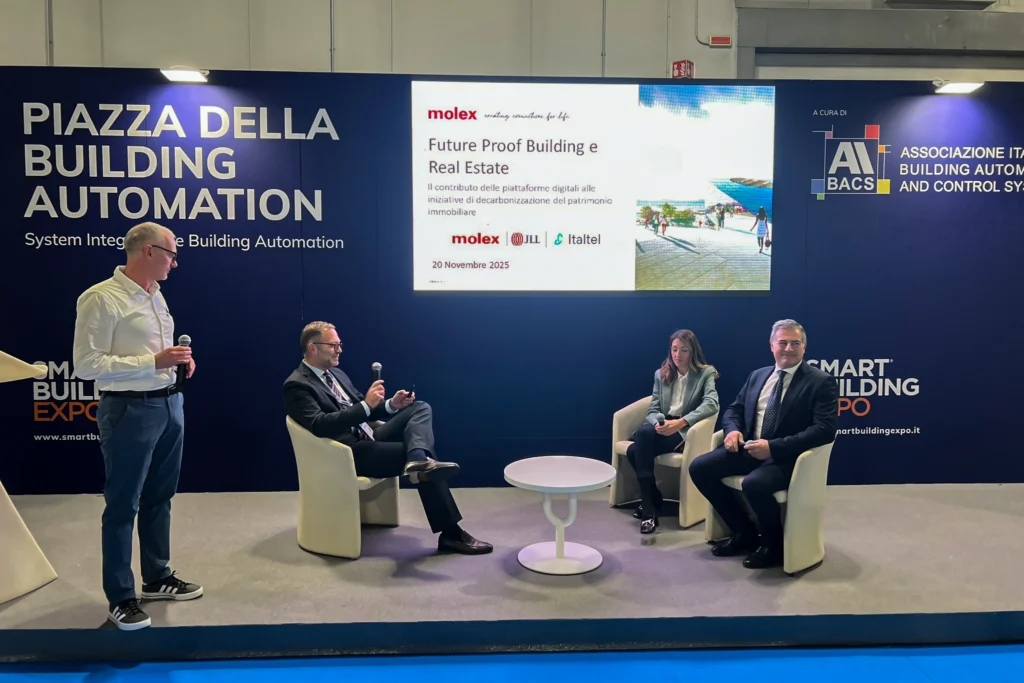 A panel discussion at a building automation expo featuring speakers discussing digital platforms for real estate and decarbonization.