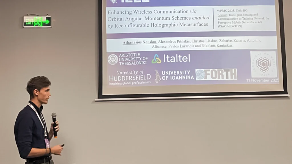 A man talking at a conference with microphone explaining presentation