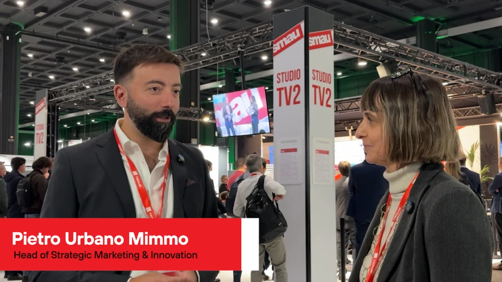 Two people in a crowded event (SMAU 2025)