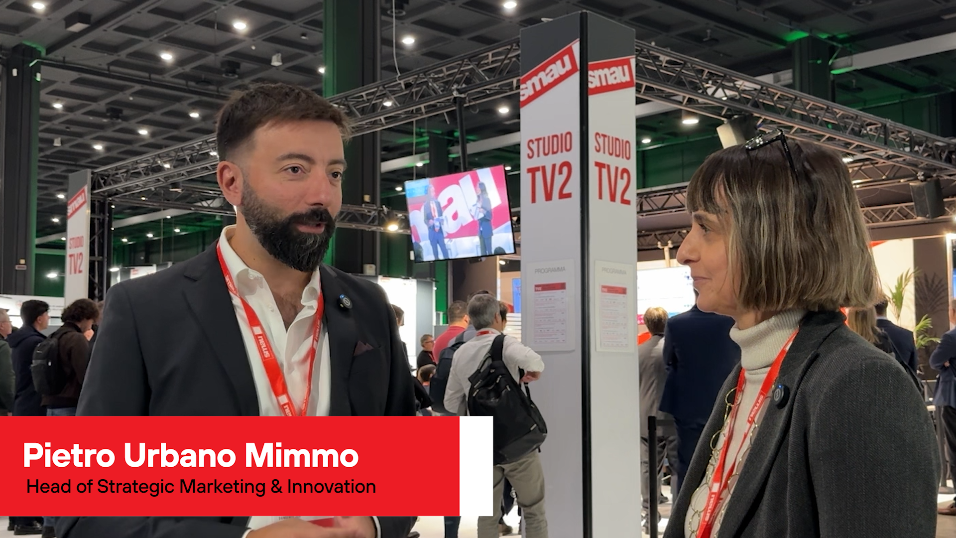Two people in a crowded event (SMAU 2025)