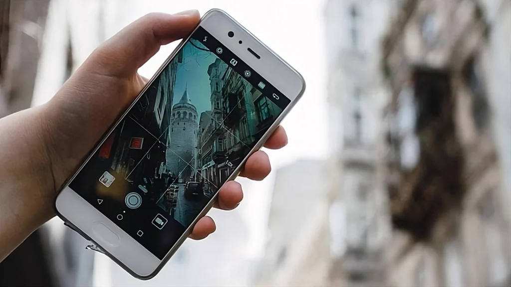 a phone taking photo with blurred landscape in the background