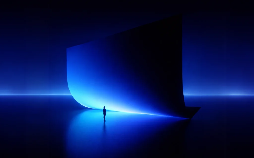 A lone figure stands before a towering, curved structure glowing blue in a dark, futuristic setting. The scene conveys a sense of wonder and scale.
