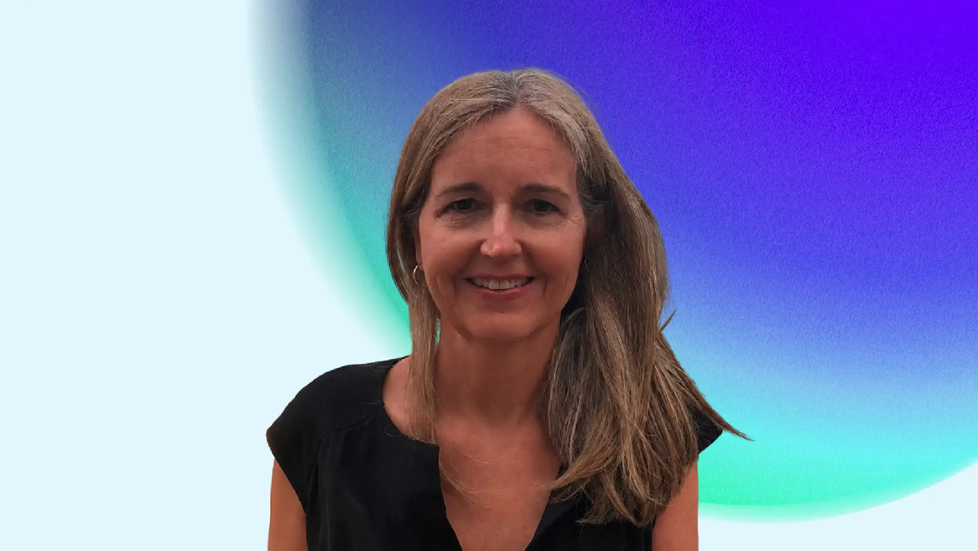 Smiling woman with long hair wearing a black top, standing against a vibrant background with a blue and purple gradient, conveying a cheerful tone